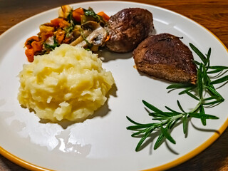 Deer steak with mushroom-vegetable ragout and mashed potatoes