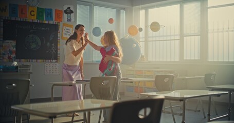 Female Teacher Finishing Lesson, Saying Goodbye to Diverse Kids at the End of School Day. Primary School Girl Packing Her Backpack, Giving Five to Teacher and Leaving School for Holidays. Slow Motion.