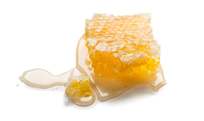 Honey in honeycombs dripping, pouring, isolated on white background. Honeycomb close-up. Healthy fresh organic liquid honey spill. 