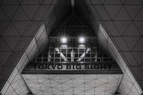 tokyo, ariake - oct 6 2024: A close-up of the Tokyo Big Sight&rsquo;s facade, a Japanese convention center renowned for its distinctive triangular and pyramidal architecture, brightly illuminated at night.