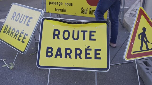Close up of multiple French road signs indicating a blocked road
