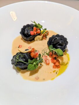 Veal Cappeletti with Tomato Concasse and Bechamel au Poivre