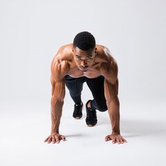 Intense Male Athlete in Running Start Position on White Background