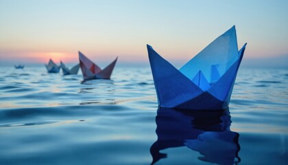 Blue origami boat leads others on calm ocean water at sunset. Other paper boats follow. Calm sea, peaceful sky horizon. Represents leadership, teamwork, journey, success, vision, hope, ambition.