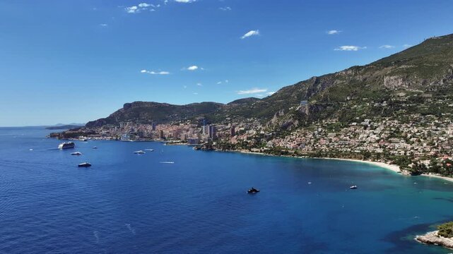 angel aerial landscape view of Mediterranean coastline of Monaco and Roquebrune-Cap-Martin, located on French Riviera with skyline as well yachts and cruise ships in the bay - 4k aerial footage