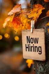 Now hiring sign in autumn glow