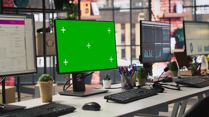Green screen PC monitors in empty call center office where unsatisfied customers call to solve technical problems. Mockup computer displays in customer support workspace, panning shot