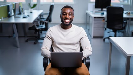 Smiling African American Man Working on Laptop in Modern Office