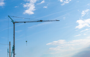Construction tower cranes on a building site in Sottomarina, Italy