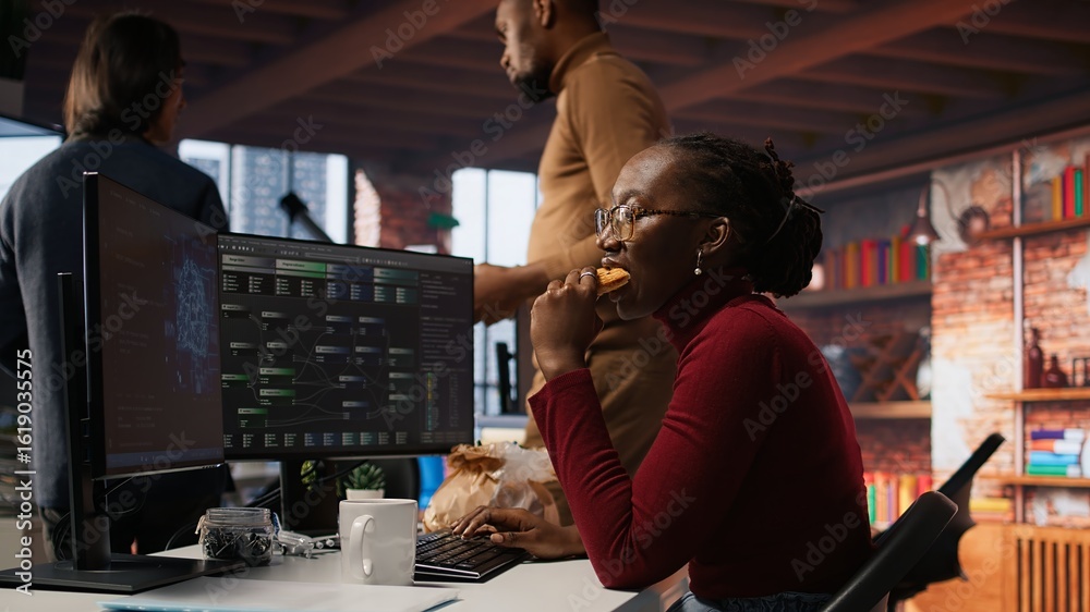 Poster programmer coding ai algorithm in startup, eating food at desk while refining machine learning model