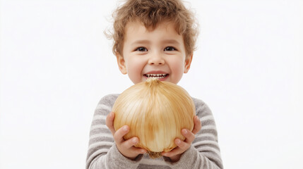 Fototapeta premium Excited child joyfully holds a large onion in hands while smiling brightly indoors