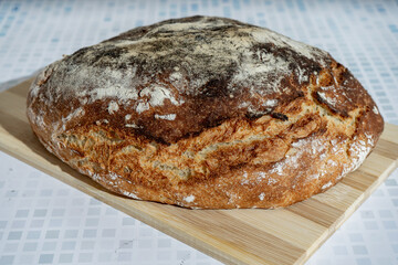Rustic homemade bread on wooden cutting board
