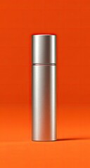 Silver bottle on orange background, product shot, studio