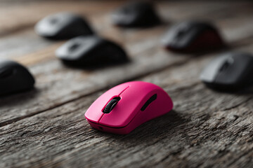Stand out A vibrant pink mouse contrasts with muted gray ones on rustic wood. Conceptual for individuality, innovation. Use for tech, business, design.