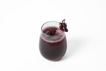 A glass of cold hibiscus tea with ice and dried hibiscus flower on a white background © Евгений Михайлов