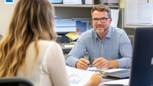 Financial advisor meeting with young client in office setting for financial planning discussion - Powered by Adobe