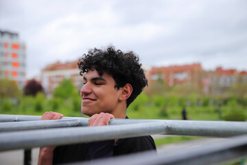 Young teenage male doing workout on sport bars, healthy lifestyle, outdoor fitness