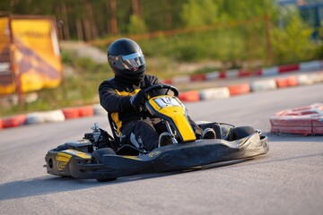 The young man races go karts on the track