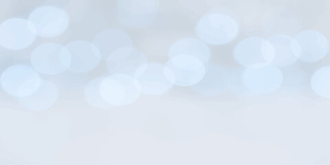 Abstract glowing bokeh background in pastel blue tones with soft circular highlights