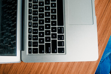 Young woman wearing a purple sweater using her computer for study at her desk. Remote work.