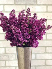 Lilac flower bouquet in modern vase