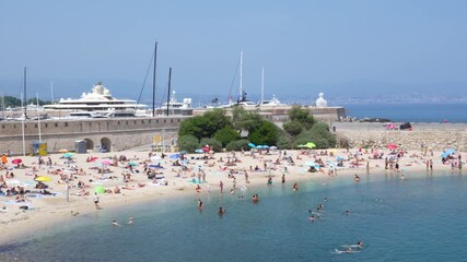 Antibes, France - June 12 2025: Busy Beach on Beautiful Coastal Cote d'Azur French Riviera in Summer. Blue Water Mediterranean Holiday Busy Travel