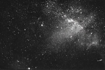 Obraz premium A vast expanse of night sky, speckled with stars and a hazy nebula