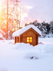 A charming, small wooden cabin is nestled in deep snow, with warm light glowing from its windows, under a soft sunset. It perfectly captures a cozy, tranquil winter escape.