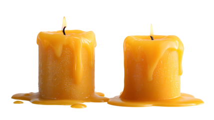 Two melting yellow candles burning bright dark background