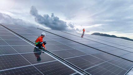 Engineers or technicians in safety gear meticulously inspecting and maintaining large-scale solar...