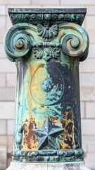 Ornate Verdigris Column Capital with Scrollwork Detailing and Weathered Texture in an Urban Setting