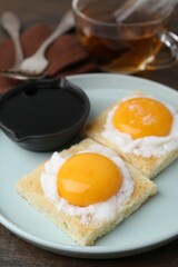 Tasty kaya toasts with half-boiled eggs served on table, closeup. Traditional asian breakfast