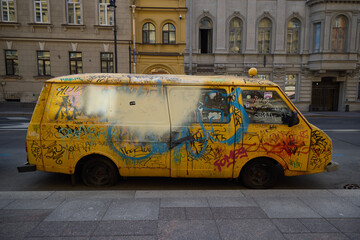 A beautiful and vibrant display of colorful urban art painted on a vintage yellow van