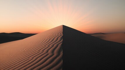 Dramatic desert landscape illuminated by the sun's rays piercing the dune crest
