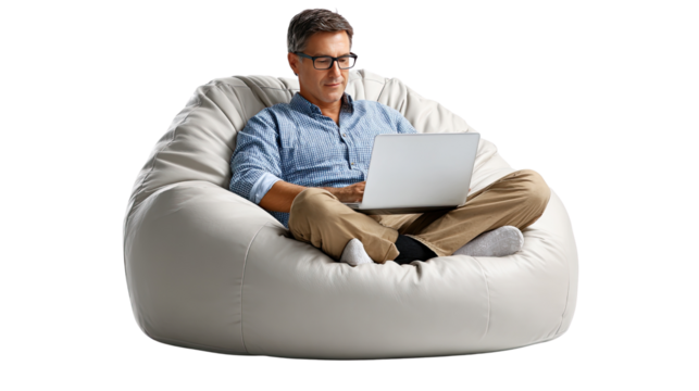Relaxed Work from Home: A man in casual attire, perched comfortably in a bean bag chair, engrossed in his laptop, perfectly embodies the modern work-from-home lifestyle.