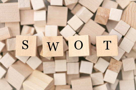 SWOT (strengths, weaknesses, opportunities, threats) concept. Abstract geometric wooden dice.  SWOT icon. Horizontal format. 