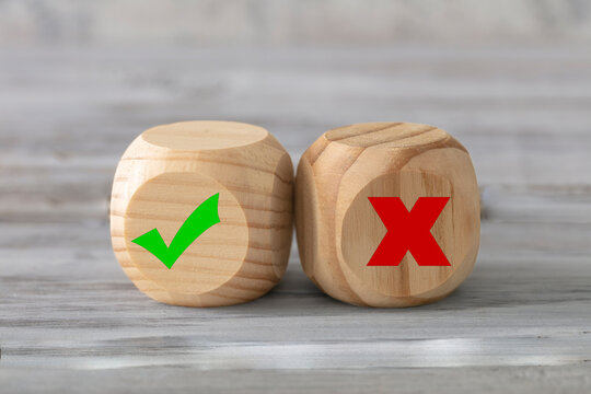 Good and bad concept. Two abstract geometric wooden dice isolate on white rustic surface. Antagonism concept. Horizontal format. 