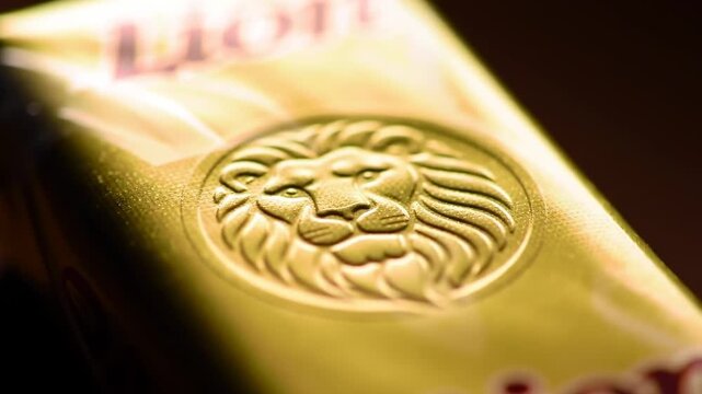 Close-up of a golden-yellow packaging with a lion logo