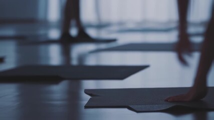 Preparing Yoga Mats in Studio for Class Practice