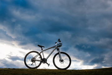 Fototapeta premium mountain bike on flowering grassland mountain top