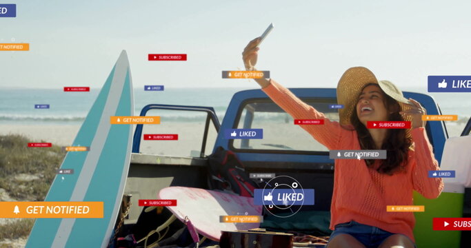 Taking selfie woman in straw hat on truck tailgate at beach, with smartphone notification icons - Powered by Adobe