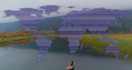 Man in red plaid jacket paddling canoe on glassy lake, with paddle, purple world map overlay