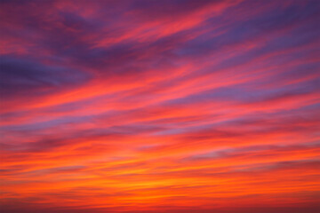 Fototapeta premium Vibrant sunset sky with fiery orange and purple hues