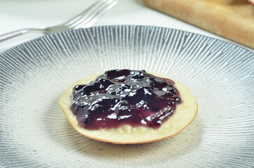 Serabi pancakes topped with blueberry jam, a traditional Indonesian snack