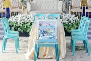 Outdoor Wedding Table Setting with Floral Backdrop and Ornate Chairs