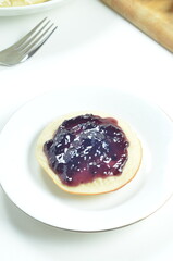 Serabi pancakes topped with blueberry jam, a traditional Indonesian snack