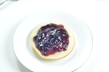 Serabi pancakes topped with blueberry jam, a traditional Indonesian snack