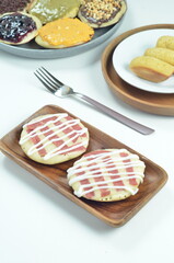 Serabi pancake topped with sliced beef and mayonnaise, a traditional Indonesian snack
