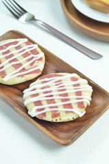 Serabi pancake topped with sliced beef and mayonnaise, a traditional Indonesian snack
