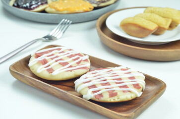 Serabi pancake topped with sliced beef and mayonnaise, a traditional Indonesian snack